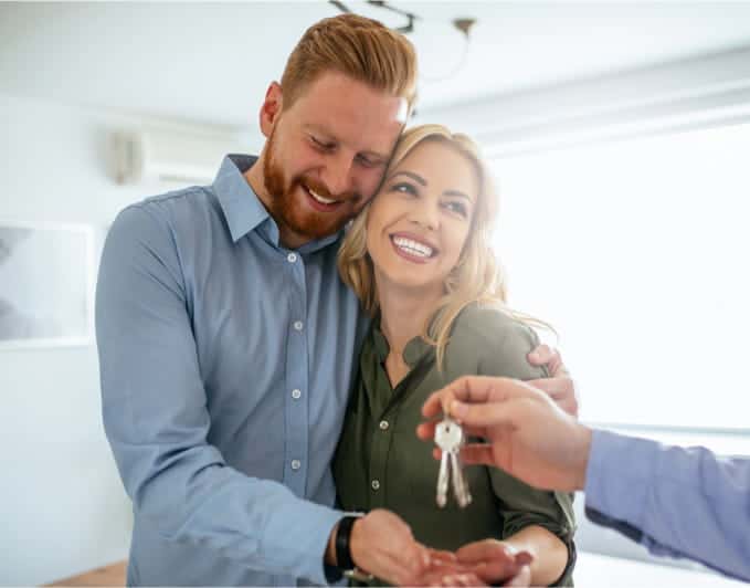 couple receiving keys for house