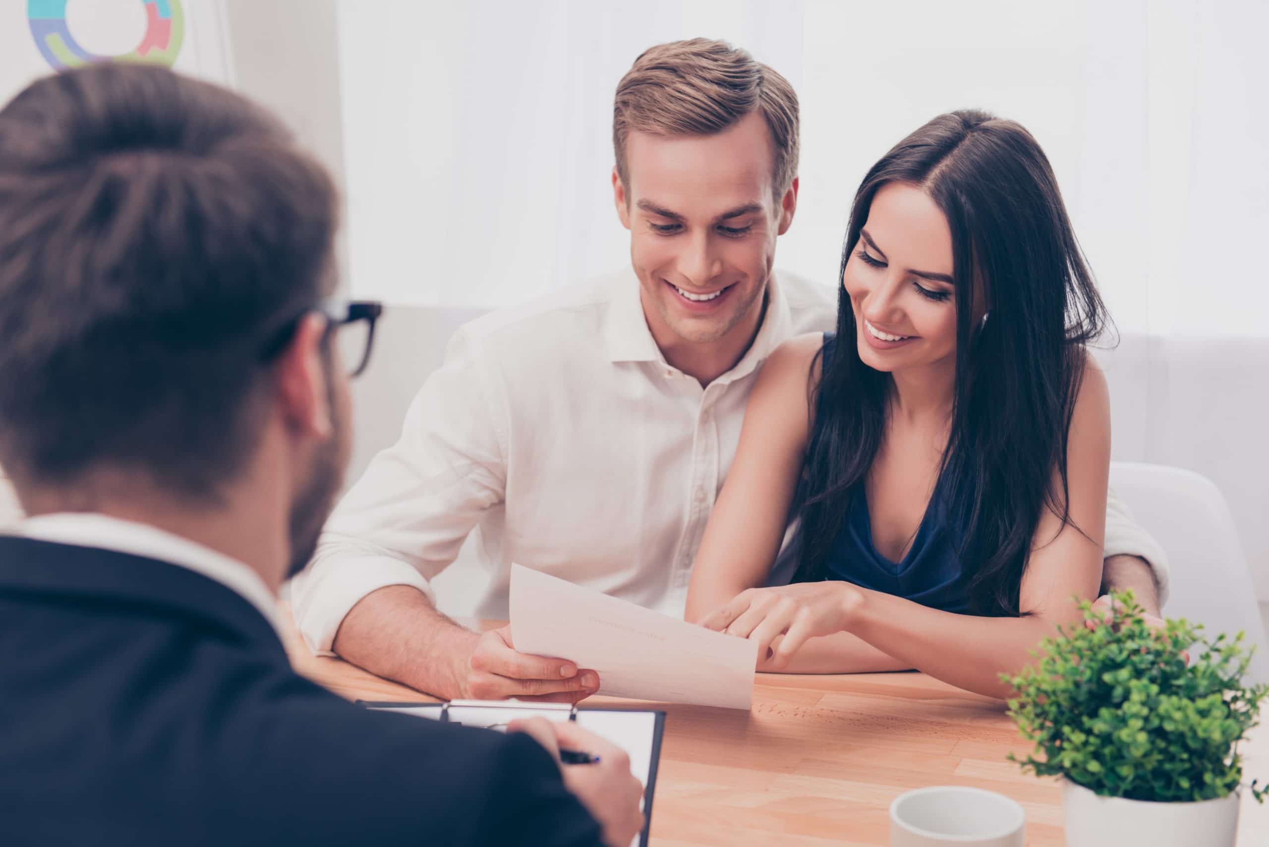 Successful lawyer giving consultation to family couple about buying a house