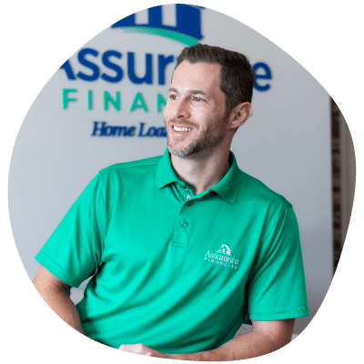 a man wearing a green assurance financial polo shirt