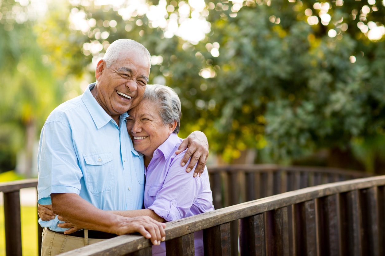 Mexican senior couple laughing on bridge