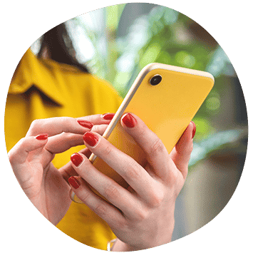 a woman with red nails holding a yellow cell phone