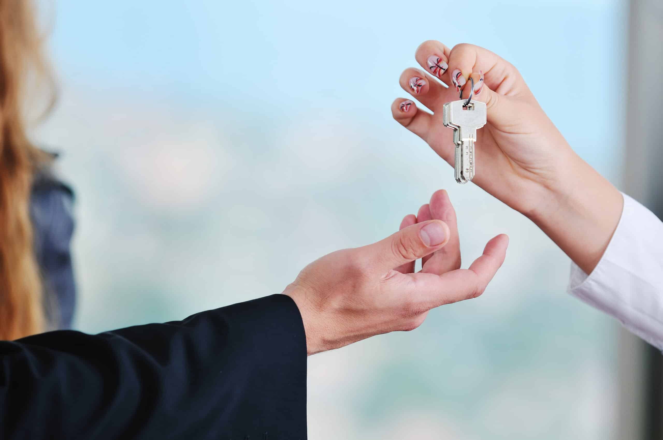 realtor handing home buyer house keys
