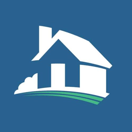 a white house with a green roof on a blue background